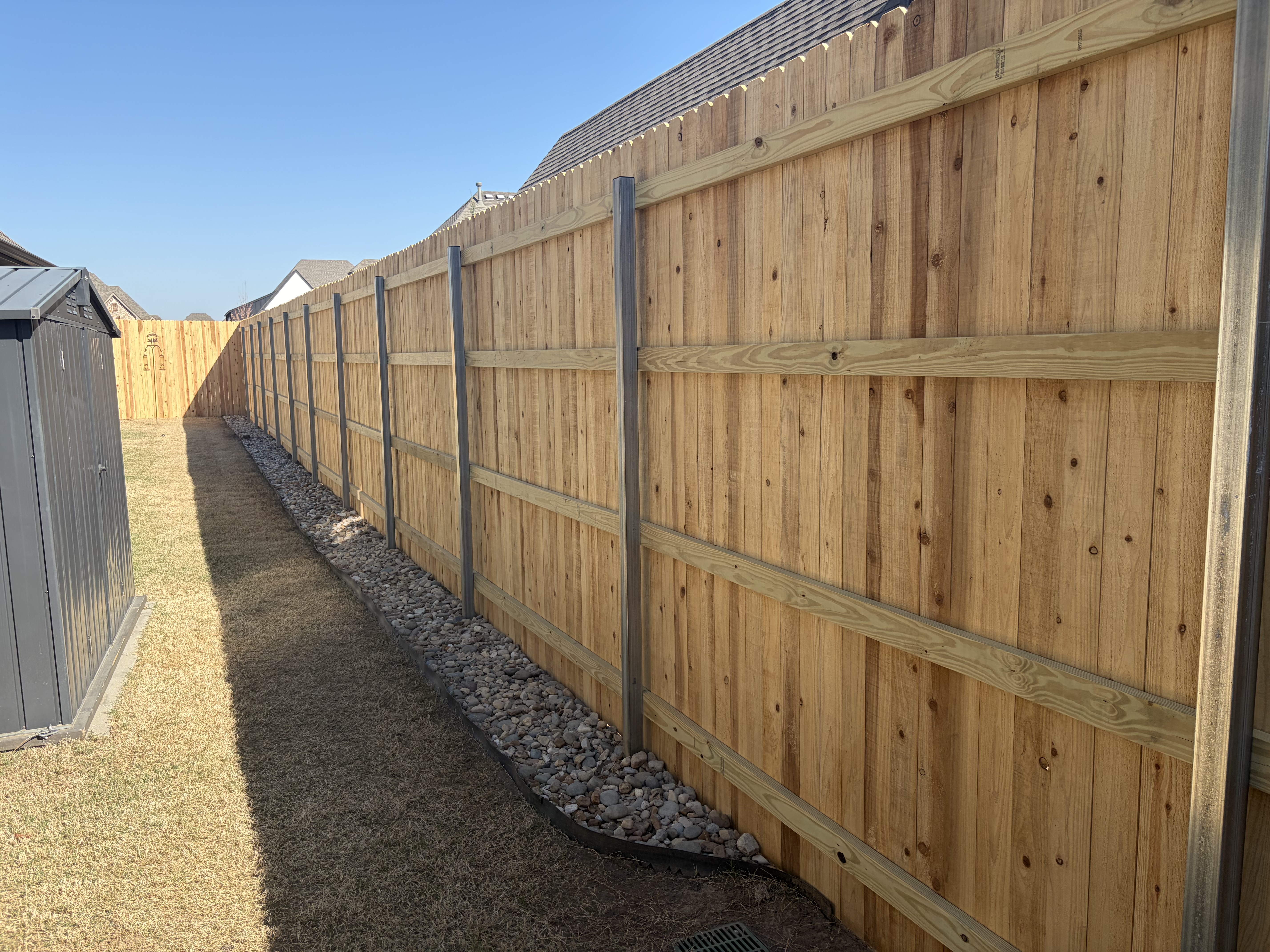 Wood fence with steel posts — residential