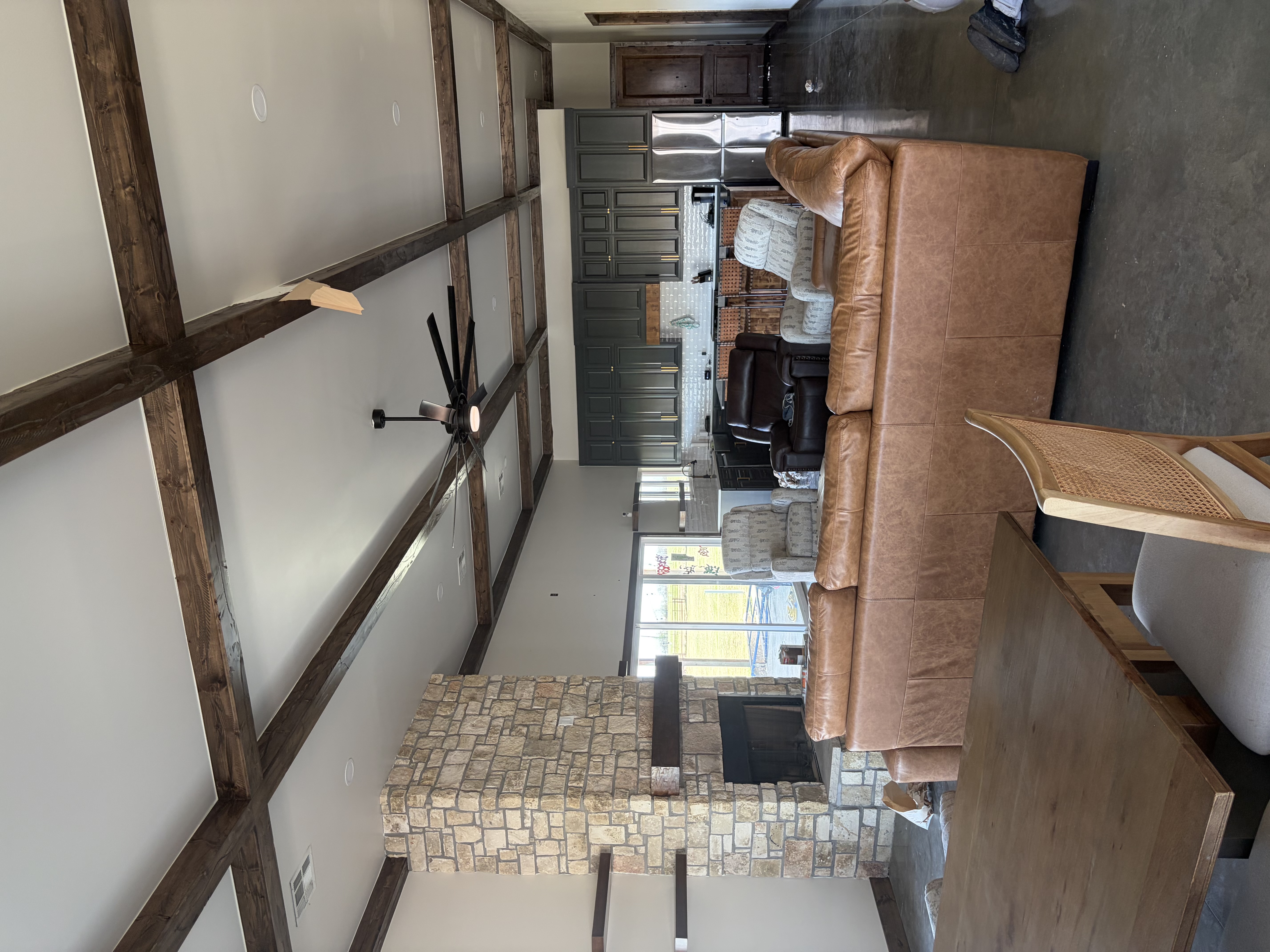 Custom home interior — exposed beams and stone fireplace