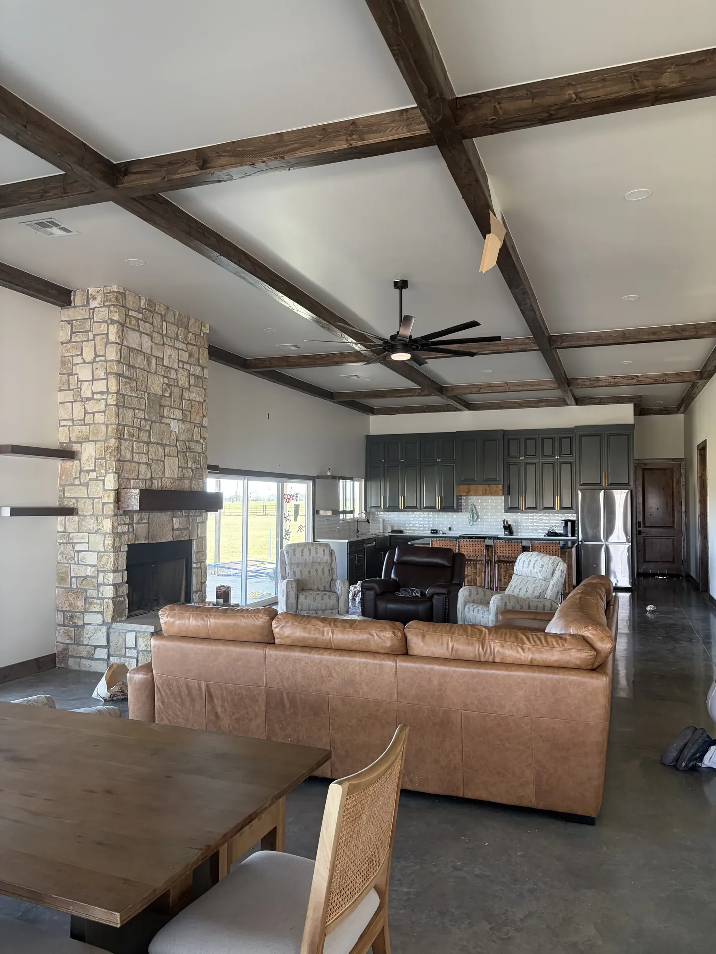 Custom home interior — exposed beams and stone fireplace
